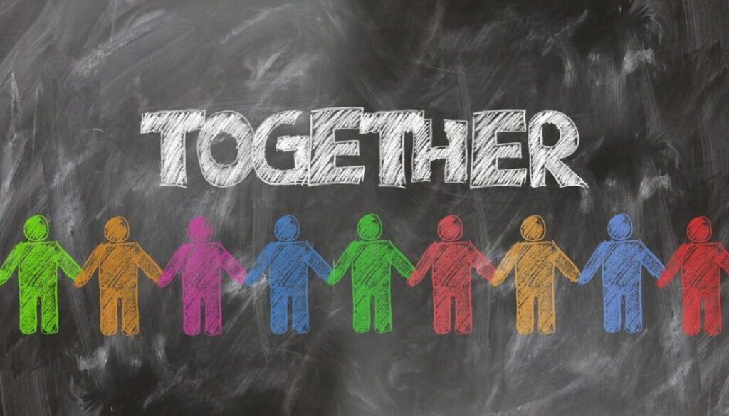 diegno su lavagna. persone colorate che si tengono per mano e scritta together