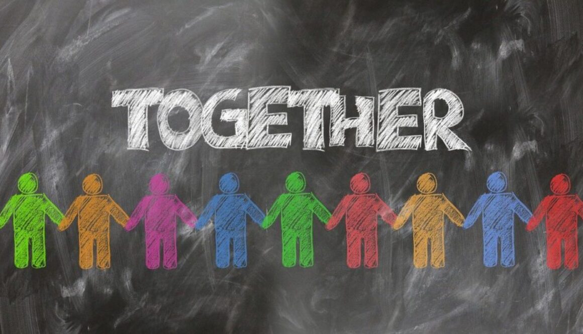 diegno su lavagna. persone colorate che si tengono per mano e scritta together