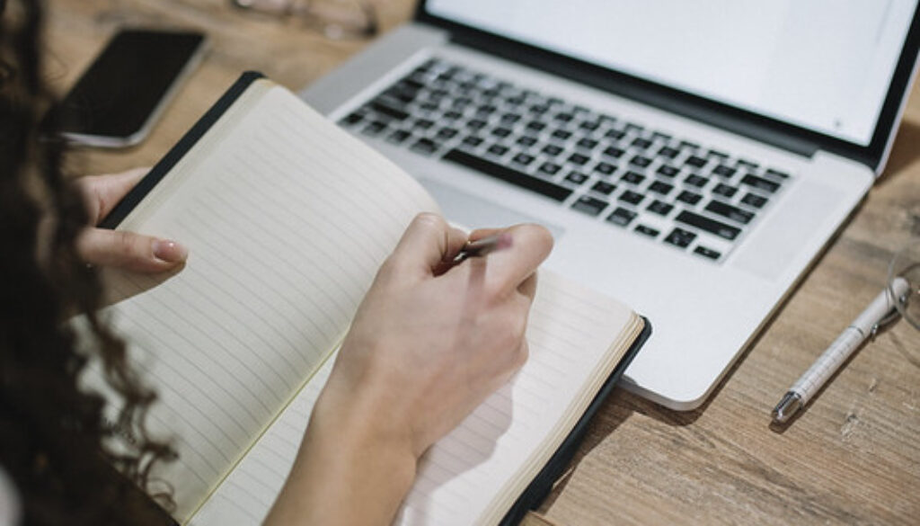 A young woman taking notes
