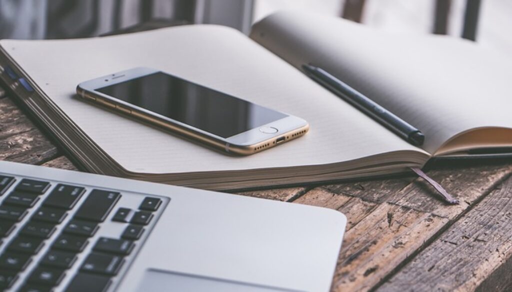 scrivania con quaderno penna telefono computer